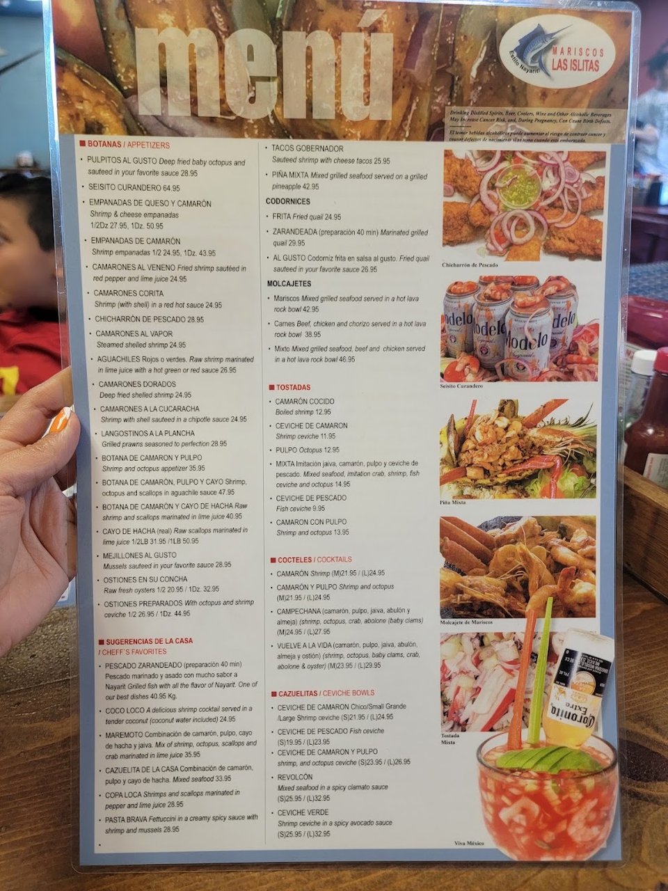 Restaurant menu with mariscos specialties listed.